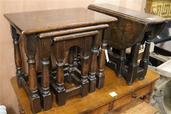 An oak oval gateleg table and a nest of three oak tables